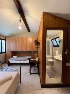 a bedroom with a bed and a desk and a bathroom at B&B Garzola in Ossuccio +130 photos
