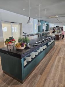a kitchen with bowls of fruit on a counter at Amadria Park Grand Hotel 4 Opatijska Cvijeta in Opatija