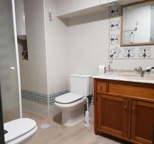 a bathroom with a toilet and a sink at Cala del Pino in La Manga del Mar Menor +95 photos