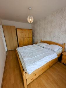 a bedroom with a large bed with white sheets at Apartmán Stavidlový Vrch in Vrchlabí