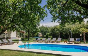 a swimming pool with lounge chairs next to a pool at Villa Ante - Makarska by Villas Guide in Gornja Glavina