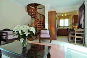 a living room with a vase of flowers on a table at Kerveli Luxury Villa in Kerveli