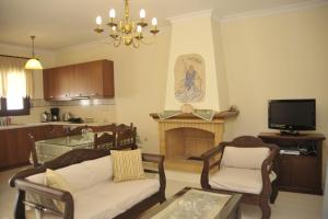 a living room with a couch and a fireplace at Kerveli Luxury Villa in Kerveli