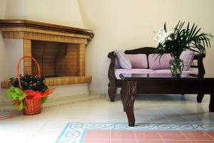 a living room with a couch and a table at Kerveli Luxury Villa in Kerveli