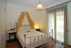 1 dormitorio con 1 cama con dosel en Kerveli Luxury Villa en Kerveli