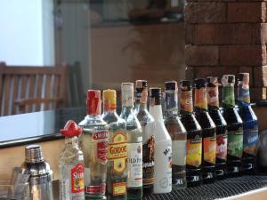 a group of bottles of alcohol sitting on a table at Katanoi Resort in Kata Beach