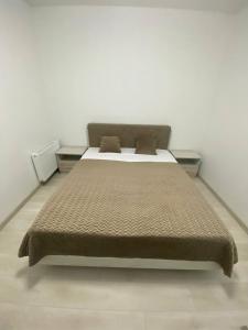 a bedroom with a large bed with two pillows at ATLANT luxury Big Family Five Apart - ТЦ ДЕПОТ in Chernivtsi