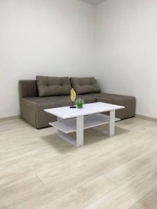 a living room with a couch and a white coffee table at ATLANT luxury Big Family Five Apart - ТЦ ДЕПОТ in Chernivtsi +23 photos