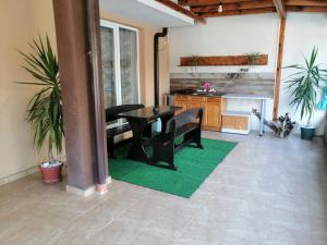 a living room with a table and a kitchen at Path ways to the Sea -Пътека към морето in Primorsko +3 photos