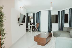 a living room with a couch and a table at Le Parvis Résidences in Yaoundé