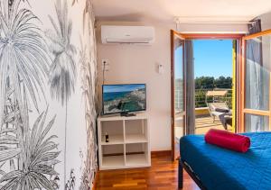 a bedroom with a blue bed and a balcony at Marelì - magnifica villa con piscina in Livorno +64 photos