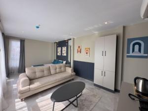 a living room with a couch and a table at Sky Luxe Hotel Konyaaltı in Antalya