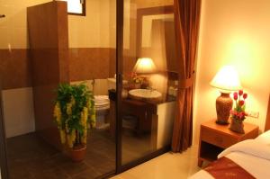 a bathroom with a sink and a toilet and a shower at Katanoi Resort in Kata Beach
