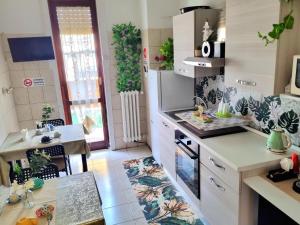 a kitchen with a sink and a stove top oven at Italo House in Opera +26 photos