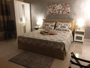 a bedroom with a bed with a teddy bear on it at Dimore Angye in Termoli