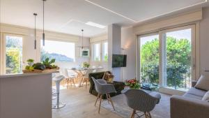 a living room with a kitchen and a dining room at Luxury Apartments in Modern Villa in Imperia