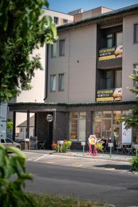 a building with a store on the side of a street at Emerald Residence Apartments in Dunajská Streda +45 photos