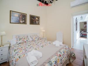a bedroom with a bed with towels on it at Casa Guirigay in Sanlúcar de Barrameda +70 photos