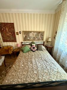 a bedroom with a large bed with pillows at Old Town Riverside Antique Gallery Self Check-In in Klaipėda