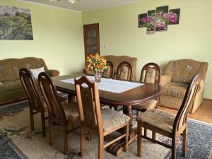 a dining room with a table and chairs at Noclegi w Beskidzie Wyspowym in Przenosza +1 photo