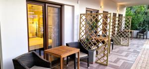 a patio with a table and chairs on a porch at My Afytos Garden in Afitos +54 photos