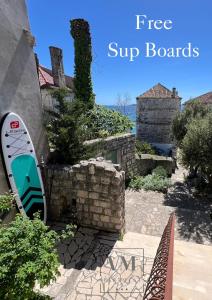 a surfboard sitting on the side of a building at VM Apartments in Orebić