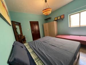 a bedroom with a large bed and a window at Triple room in Beautiful Maltese Maisonette in St Julian's
