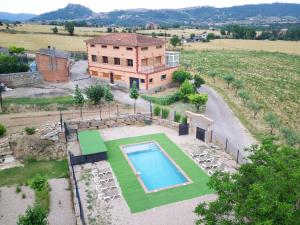 an aerial view of a house with a swimming pool at El Castellot - Turisme rural in Cardona