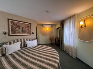 Postel nebo postele na pokoji v ubytování Hotel Dafi