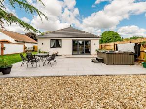 a patio with a table and chairs and a barbecue at 2 Bed in Hedon 89596 in Ryhill