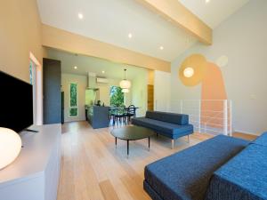 a living room with a couch and a table at Minn house Niseko Hirafu in Kutchan