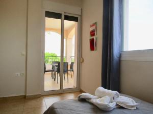 a bedroom with a bed and a view of a balcony at Barbati Beach Apartments in Barbati +73 photos