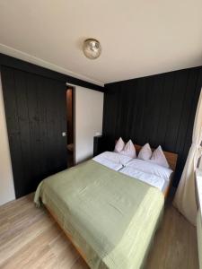 a bedroom with a large bed with a black headboard at Wohnung Albrecht Nummer 4 in Spalt