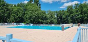 a large swimming pool with people in the water at Enolange in Monflanquin