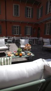 a patio with a table with food on it at Corte Novella Hotel & Residence in Brescia