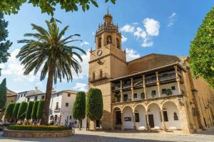 a building with a clock tower on top of it at La Casita de Ronda in Ronda