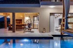 a house with a swimming pool next to a house at Villa Alba ZadarVillas in Vrana