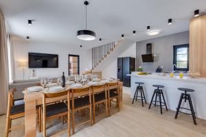 a kitchen and living room with a large table and chairs at Villa Alba ZadarVillas in Vrana