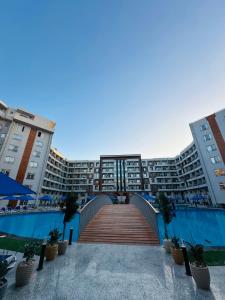 a bridge in front of a large apartment building at Unique Studio Free access beach in Hurghada