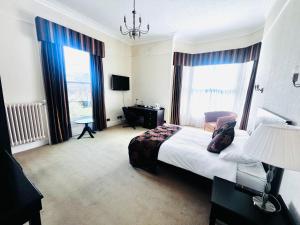 a hotel room with a bed and a large window at Lambert House in Hull