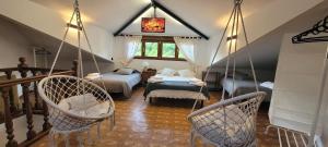 a room with two beds and two swing chairs at Casa Luisín Jacuzzi exterior Casa completa 10 personas in El Pino +8 photos