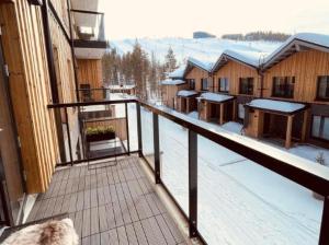 a balcony of a lodge with snow on the ground at Ski Chalet C9 Ski-in Ski-out by Aavalevi in Levi