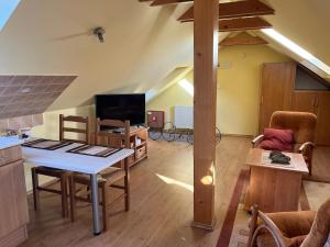 a kitchen and living room with a table and chairs at Down Town Apartment with Garden in Piešťany