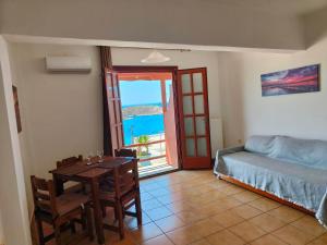 a bedroom with a table and a bed and a window at Balcony of vari in Vári