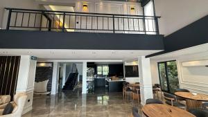 a room with tables and chairs and a balcony at Parna Sapanca Hotel in Sakarya