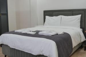 a bed with white sheets and towels on it at Parna Sapanca Hotel in Sakarya +11 photos