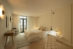 a bedroom with a bed and a desk and a table at Almaré in Los Llanos de Aridane
