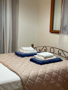 two stacks of pillows sitting on top of a bed at Poliana Holiday Home in Kotrónion