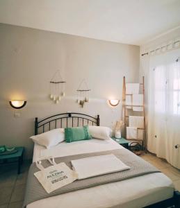 a bedroom with a bed with towels on it at Alezina studios in Amorgos