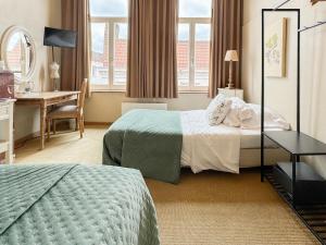 Postel nebo postele na pokoji v ubytování Hotel Botaniek + 17 fotografií
